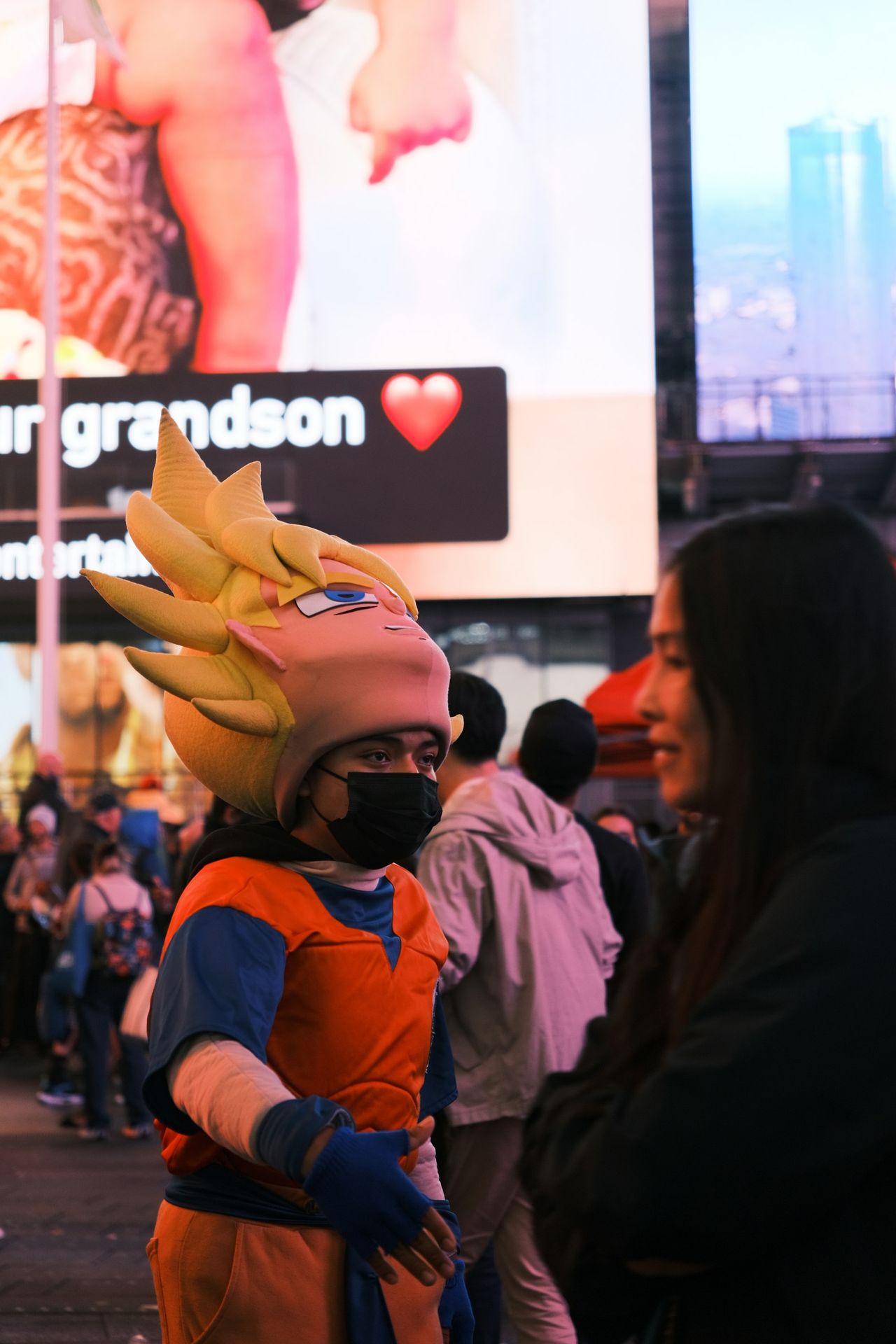 a person in a costume standing in front of a billboard